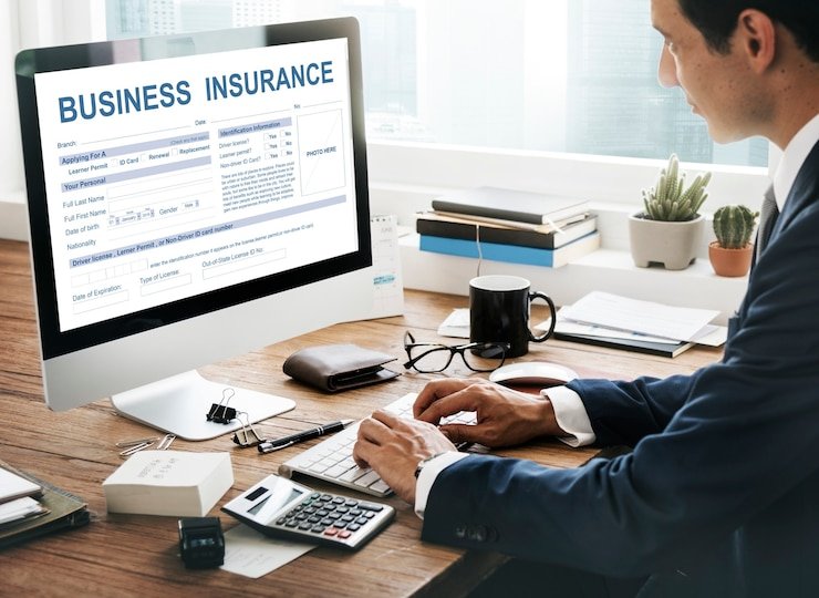 Business owner protecting small business with umbrella symbolizing insurance coverage in 2025