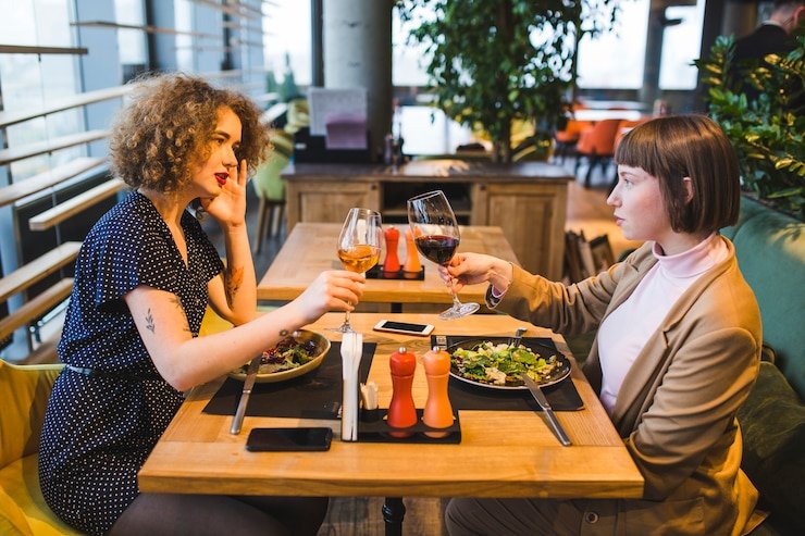 People dining at a healthy fast-casual restaurant with fresh salads and bowls