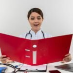 Health Information Management professional updating electronic health records in U.S. hospital