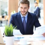 Finance professional reviewing financial data on laptop in U.S. office