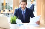 Finance professional reviewing financial data on laptop in U.S. office