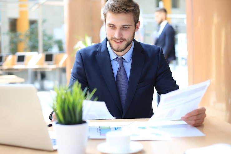 Finance professional reviewing financial data on laptop in U.S. office