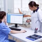Health information management technician reviewing electronic health records