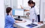 Health information management technician reviewing electronic health records
