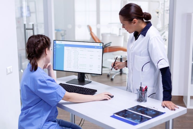 Health information management technician reviewing electronic health records