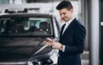 Kia Finance representative helping U.S. customer with auto loan paperwork